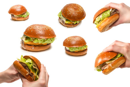Hamburger in woman hands isolated on a white background. Top view.の写真素材