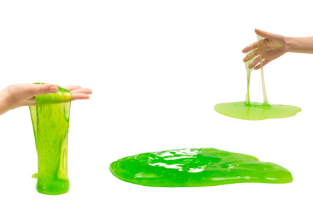 Green slime toy in woman hand isolated on white.