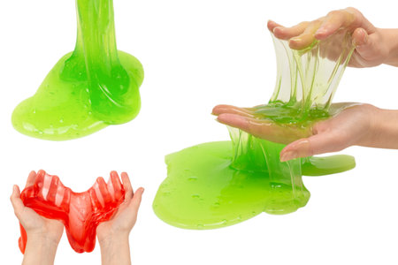 Green slime toy in woman hand isolated on white background.の写真素材