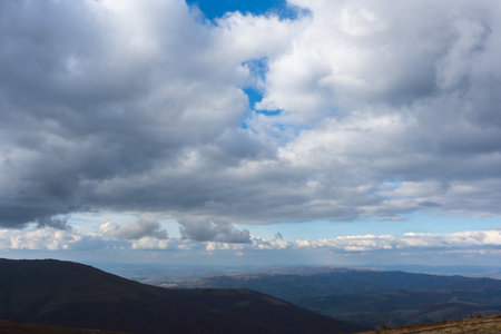 Beautiful view of the carpathian moun landscape with green meadows, trees, dark low clouds on the...