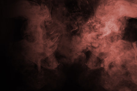 Blue and pink steam on a black background. Copy space.