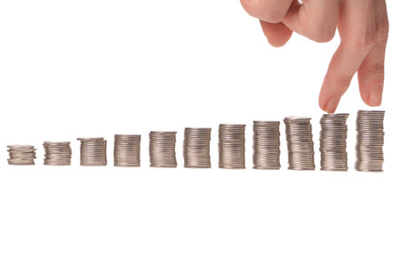 Becoming rich. Woman hand fingers walking on coins. business concept.の写真素材