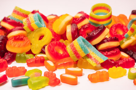 Assorted colorful gummy candies. top view. Jelly donuts. Jelly bears. isolated on a white...