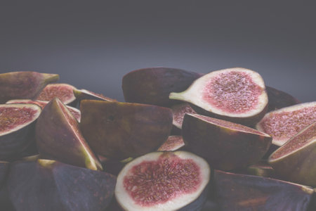 Tasty figs on a black background. top view. slices.