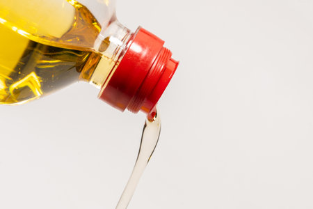 A bottle of sunflower oil isoalted on a white background. Oil pouring from a bottle.の写真素材