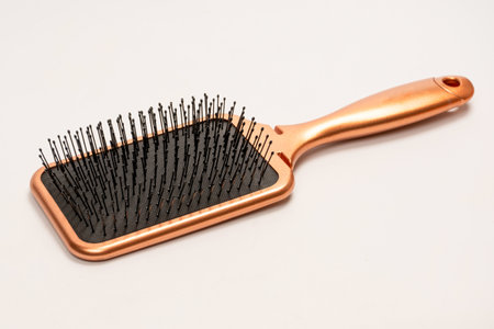 A red hairbrush isolated on a white background. beauty tool. hair tool.の写真素材