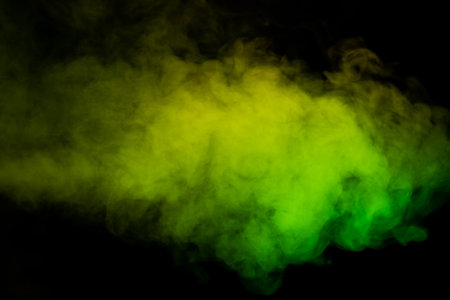 Yellow and green steam on a black background. copyspace.の写真素材