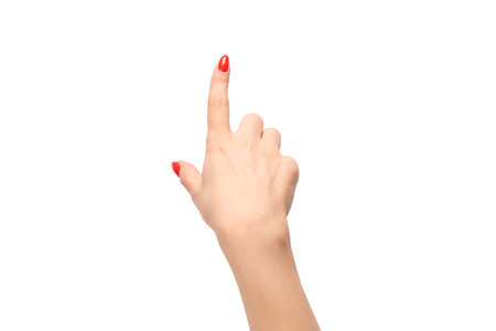 Closeup of female hand with pale skin and red nails pointing or touching isolated on a white background.の写真素材