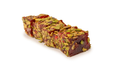 Sweet roll with pomegranate and pistachios, turkish sweets. Turkish rahat isolated on a white background.の写真素材