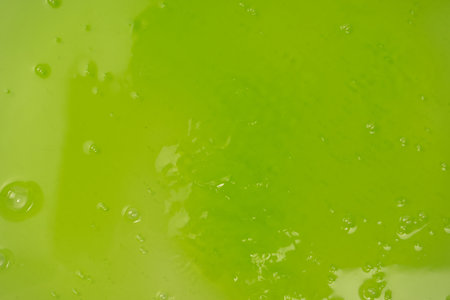 Green slime toy as a background. top view.