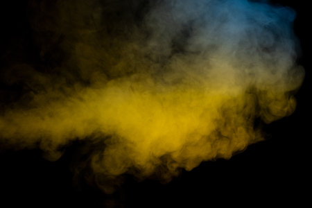 Blue and yellow steam on a black background. copyspace.の写真素材