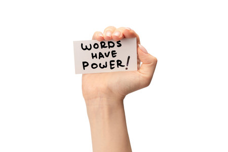 Words have power text on a card in a woman hand isolated on a white background.の写真素材