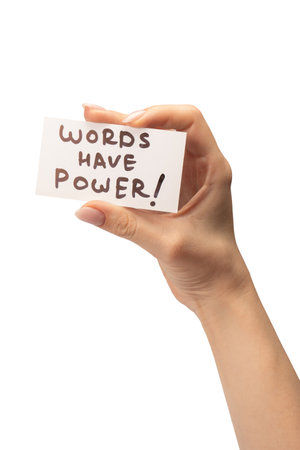 Words have power text on a card in a woman hand isolated on a white background.の写真素材
