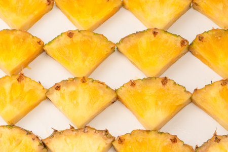 Pineapple juicy yellow slices on a white background. top view.