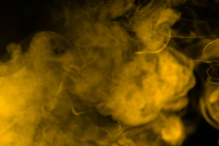 Yellow steam on a black background. Copy space.の写真素材
