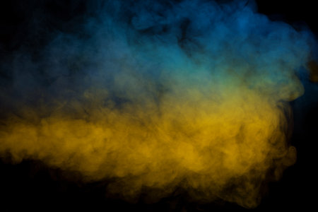 Blue and yellow steam on a black background. copyspace.の写真素材