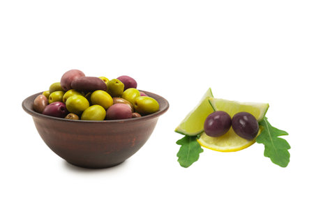 Olives in ceramic brown bowl isolated on white background.の写真素材