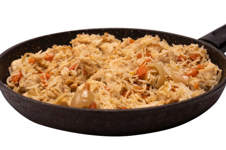 Tasty pilaf with chicken in a frying pan. isolated on a white background.の写真素材