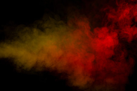 Yellow steam on a black background. Copy space.の写真素材