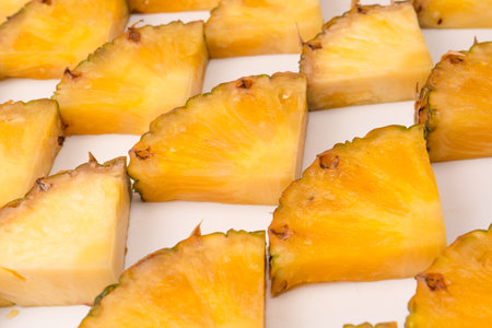 Pineapple juicy yellow slices on a white background. top view.の写真素材
