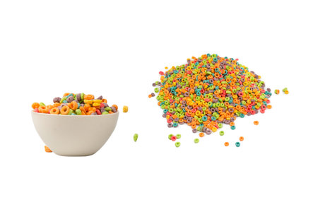 Colorful cereal box for morning breakfast. Corn flakes falling to the white bowl. Motion. Copyspace.