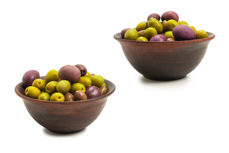 Olives in ceramic brown bowl isolated on white background.の写真素材