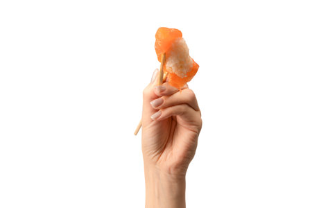 Sashimi with salmon in a woman hand isolated on a white background.の写真素材