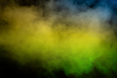 Yellow and green steam on a black background. Copy space.の写真素材