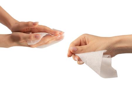 Wet wipe in a woman hand isolated on a white background. Washing hands isolated.の写真素材