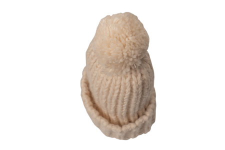 Beige warm beanie hat with pom pom isolated on a white background.の写真素材