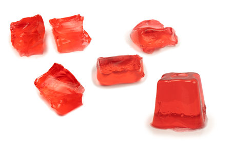 Sweet fruit jelly dessert isolated on a white background. gelatin cubes.の写真素材