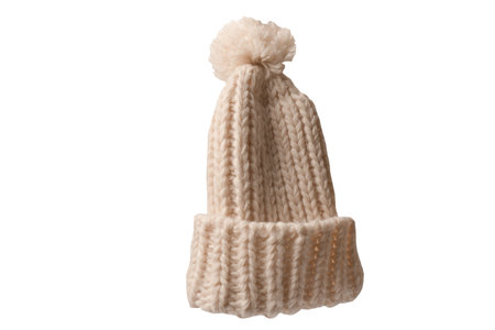 Beige warm beanie hat with pom pom isolated on a white background.の写真素材