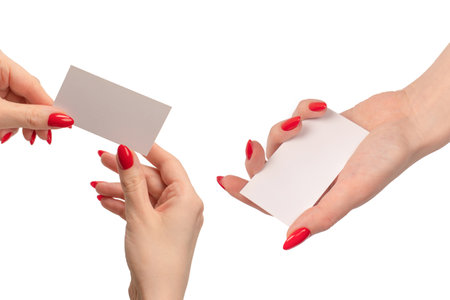 Empty card in woman hand with red nails isolated on a white background. copyspace.の写真素材