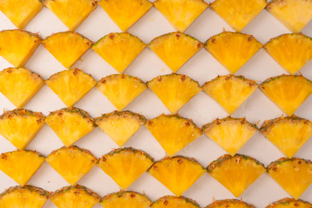 Pineapple juicy yellow slices on a white background. top view.