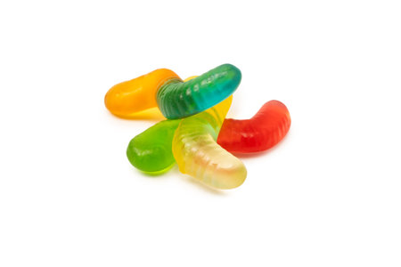 Juicy colorful jelly sweets isolated on white. Gummy candies. Jelly snakes.