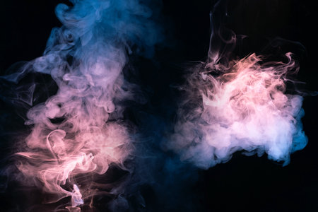 Blue and pink steam on a black background. Copy space.の写真素材