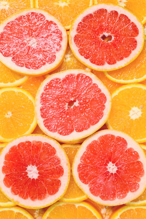 Slices of oranges and a grapefruits as a background.の写真素材