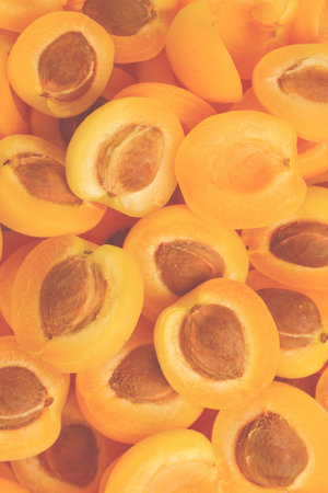 Ripe juicy orange apricots slices fruit background.の写真素材