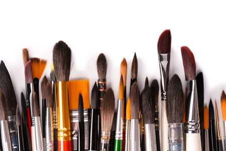 Mix of paint brushes in a row isolated on a white background. Top view.の写真素材