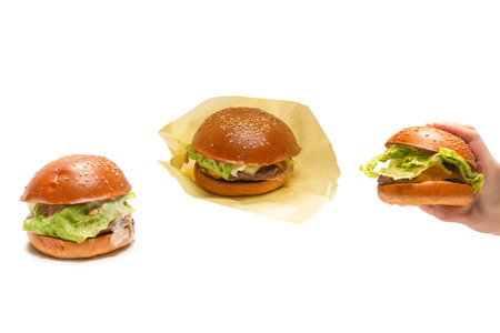 Hamburger in woman hands isolated on a white background. Top view.の写真素材