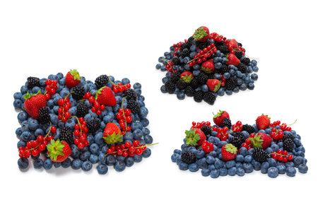 Blackberry, raspberry, blueberry, red currant isolated on a white background. Top view.の写真素材