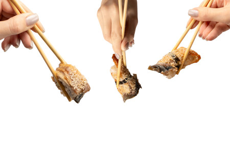 Unagi sushi in a woman hand isolated on a white background.の写真素材