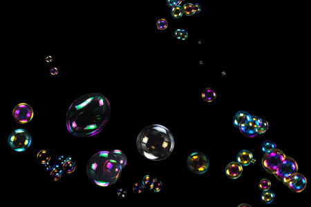 Soap bubbles isolated on a black background. Copy space.