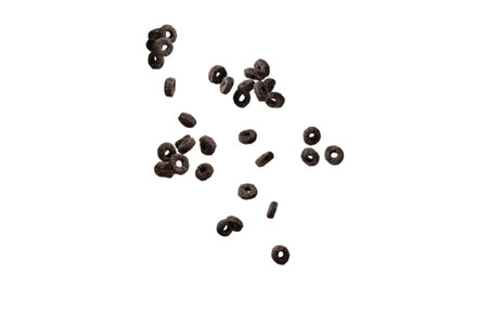Chocolate rings cereal spill out into a bowl. Breakfast. Isolated on a white background.の写真素材