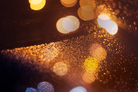 Blurred background with raindrops and lights.の写真素材