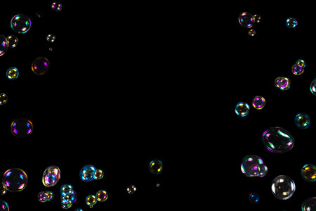 Soap bubbles isolated on a black background. Copy space.
