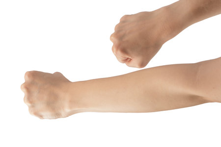 Woman's hands with fist gesture isolated on a white background.の写真素材