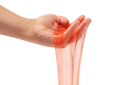 Red slime in hand isolated on white. Top view.の写真素材