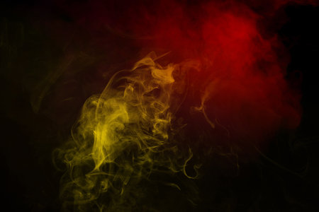 Yellow and pink steam on a black background. Copy space.の写真素材