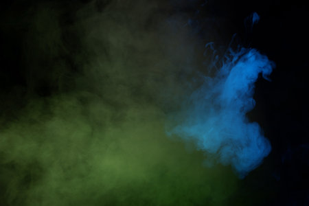 Green and white steam on a black background.の写真素材